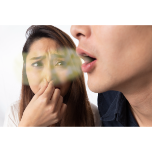 Woman with very bad smelling breath breathes on her friend